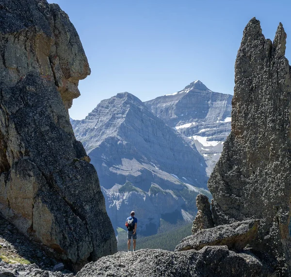 Wandelaar tussen grote rotsen genieten van uitzicht op de bergen, Canadese Rockies, Canada — Stockfoto