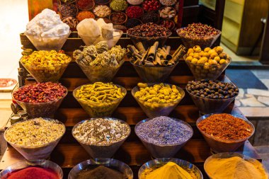 Variety of colorful Arabic spices and herbs on the Arab street market stall. Dubai Grand Spice Souk old souq, United Arab Emirates.