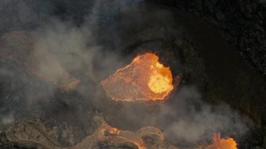 Drone shot top-down above a bubbling crater at the geldingadals volcano, Iceland