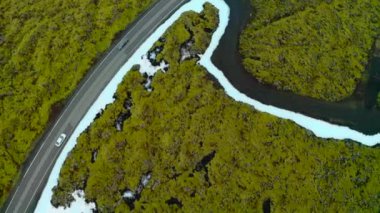 Aerial View Of White Car Driving In The Road Along The Icelandic Field In Reykjanes, Iceland.
