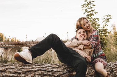 Birbirini seven çiftler bir parkın gövdesinde birbirlerine sevgi gösterirler.