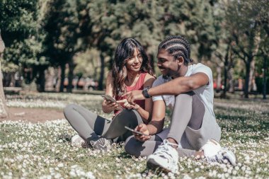 İki ırklar arası koşucu dışarıda koştuktan sonra cep telefonunu kontrol ediyor..