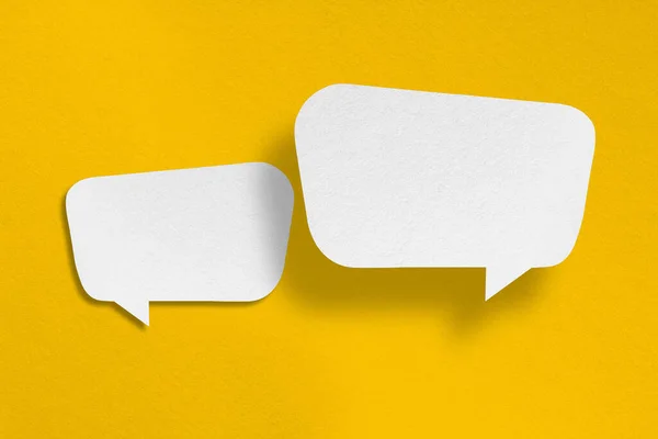 speech balloon shape white paper isolated on yellow background Communication bubbles.