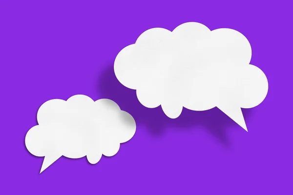 white cloud paper speech bubble shape against purple background design.