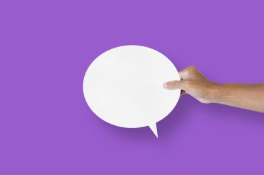 hand holding round white paper balloons speech bubbles isolated on purple background communication bubbles