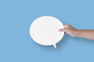 hand holding round white paper balloons speech bubbles isolated on light blue background communication bubbles