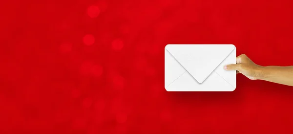 Hand Holding Christmas White Paper Envelope Red Bokeh Background — Stock Photo, Image
