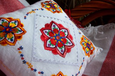 Beyaz keten yastığa renkli mandala nakış tasarımı.