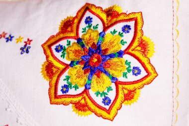 Beyaz keten yastığa renkli mandala nakış tasarımı.