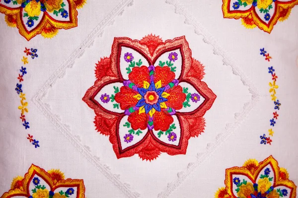 Colorful mandala embroidery design on white linen pillow. — Stock Photo, Image