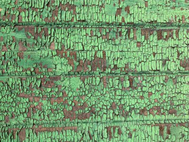 Yıpranmış boya desenli ahşap bir duvar.