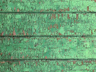 Yıpranmış boya desenli ahşap bir duvar.