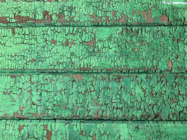 Yıpranmış boya desenli ahşap bir duvar.