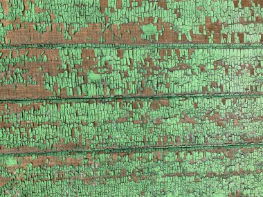 Yıpranmış boya desenli ahşap bir duvar.