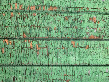 Yıpranmış boya desenli ahşap bir duvar.