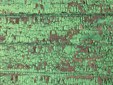 Yıpranmış boya desenli ahşap bir duvar.