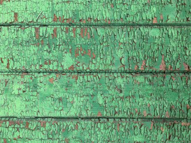 Yıpranmış boya desenli ahşap bir duvar.