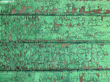 Yıpranmış boya desenli ahşap bir duvar.