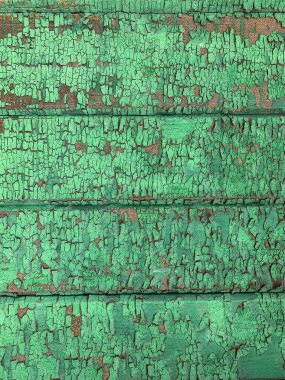 Yıpranmış boya desenli ahşap bir duvar.