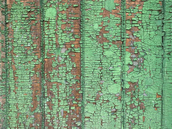 Yıpranmış boya desenli ahşap bir duvar.