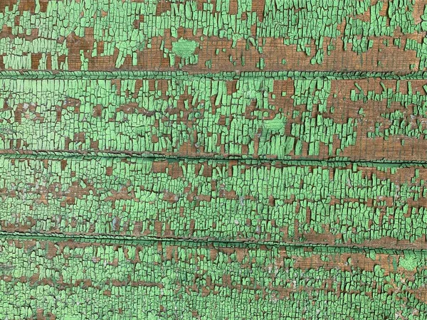 Yıpranmış boya desenli ahşap bir duvar.