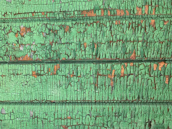 Yıpranmış boya desenli ahşap bir duvar.