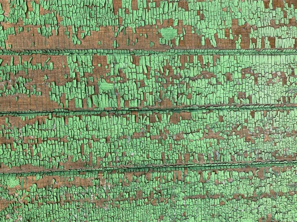 Yıpranmış boya desenli ahşap bir duvar.