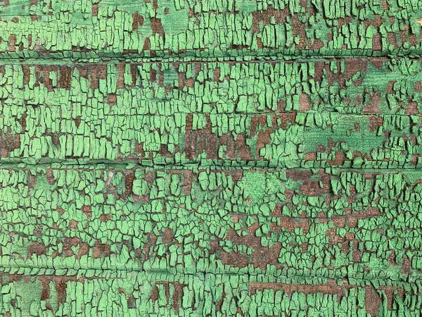 Yıpranmış boya desenli ahşap bir duvar.