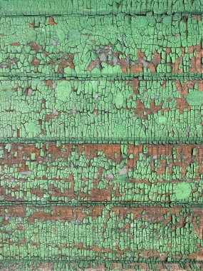 Yıpranmış boya desenli ahşap bir duvar.