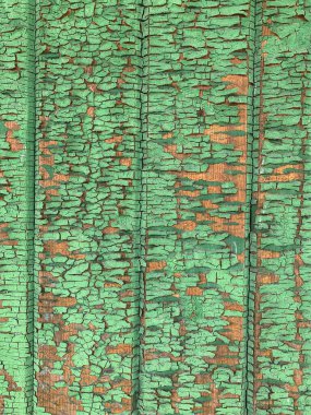 Yıpranmış boya desenli ahşap bir duvar.