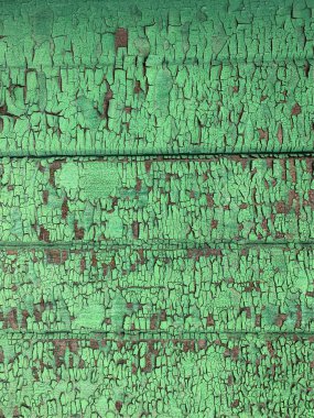 Yıpranmış boya desenli ahşap bir duvar.