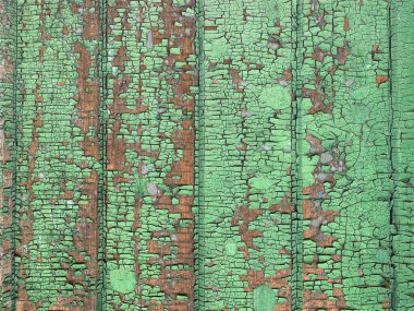 Yıpranmış boya desenli ahşap bir duvar.