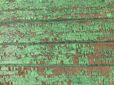 Yıpranmış boya desenli ahşap bir duvar.