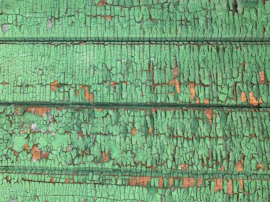 Yıpranmış boya desenli ahşap bir duvar.