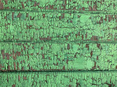 Yıpranmış boya desenli ahşap bir duvar.