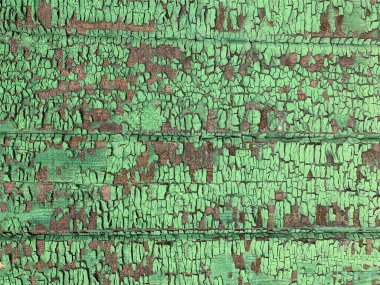 Yıpranmış boya desenli ahşap bir duvar.