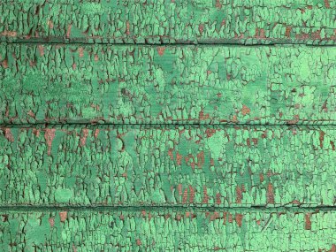 Yıpranmış boya desenli ahşap bir duvar.