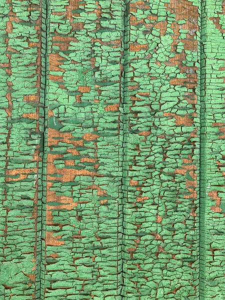 Yıpranmış boya desenli ahşap bir duvar.