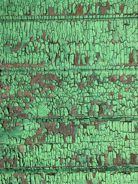 Yıpranmış boya desenli ahşap bir duvar.