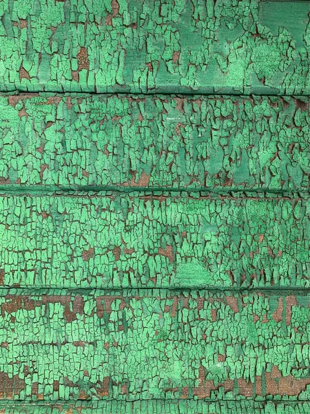 Yıpranmış boya desenli ahşap bir duvar.
