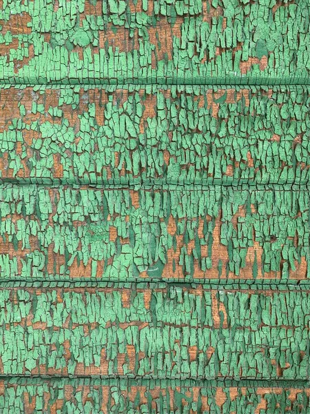 Yıpranmış boya desenli ahşap bir duvar.