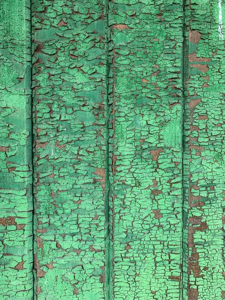 Yıpranmış boya desenli ahşap bir duvar.