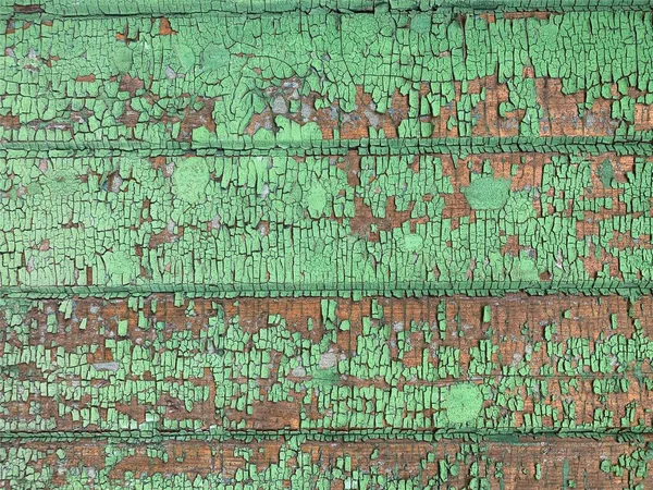 Yıpranmış boya desenli ahşap bir duvar.