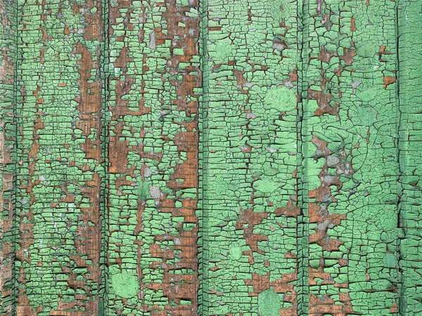 Yıpranmış boya desenli ahşap bir duvar.