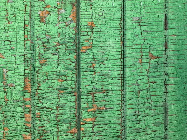 Yıpranmış boya desenli ahşap bir duvar.