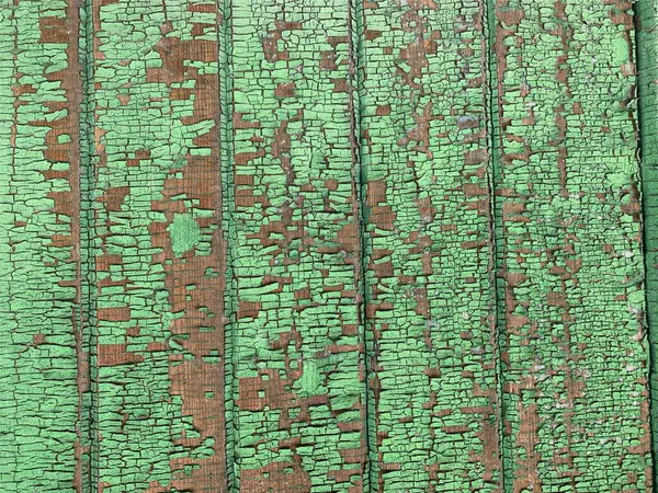 Yıpranmış boya desenli ahşap bir duvar.