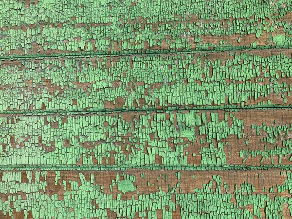 Yıpranmış boya desenli ahşap bir duvar.