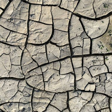 Çatlak yeryüzü arka planı. Toprak yüzeyinde çatlaklar var. Çamur çatlakları.