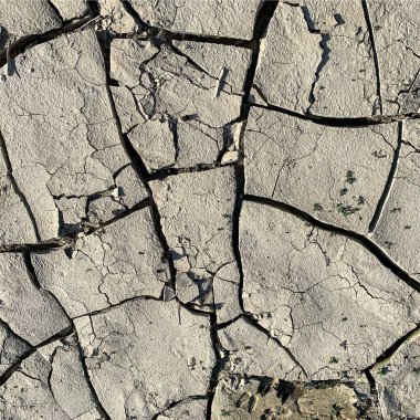 Çatlak yeryüzü arka planı. Toprak yüzeyinde çatlaklar var. Çamur çatlakları.