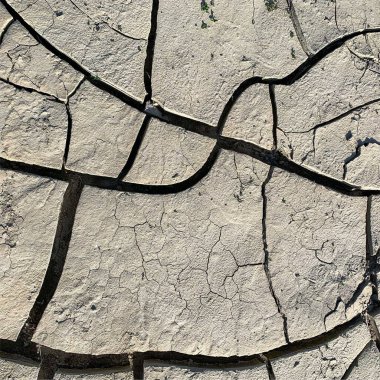 Çatlak yeryüzü arka planı. Toprak yüzeyinde çatlaklar var. Çamur çatlakları.